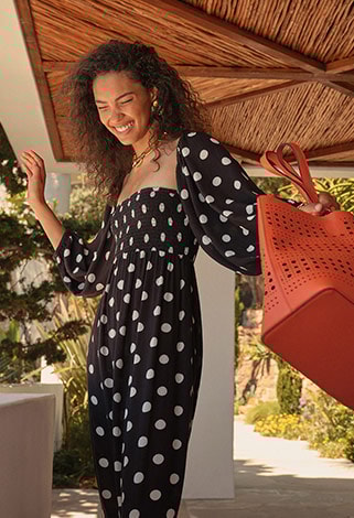 Polka dot dress and orange bag for autumn campaign. 